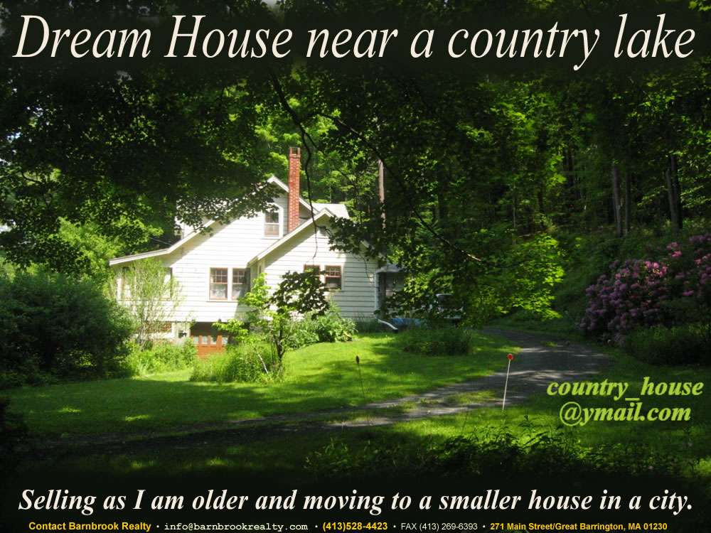 The view from the south towards this beautiful country house nestled in the woods on a main road a few steps away from a lake and a boat ramp.